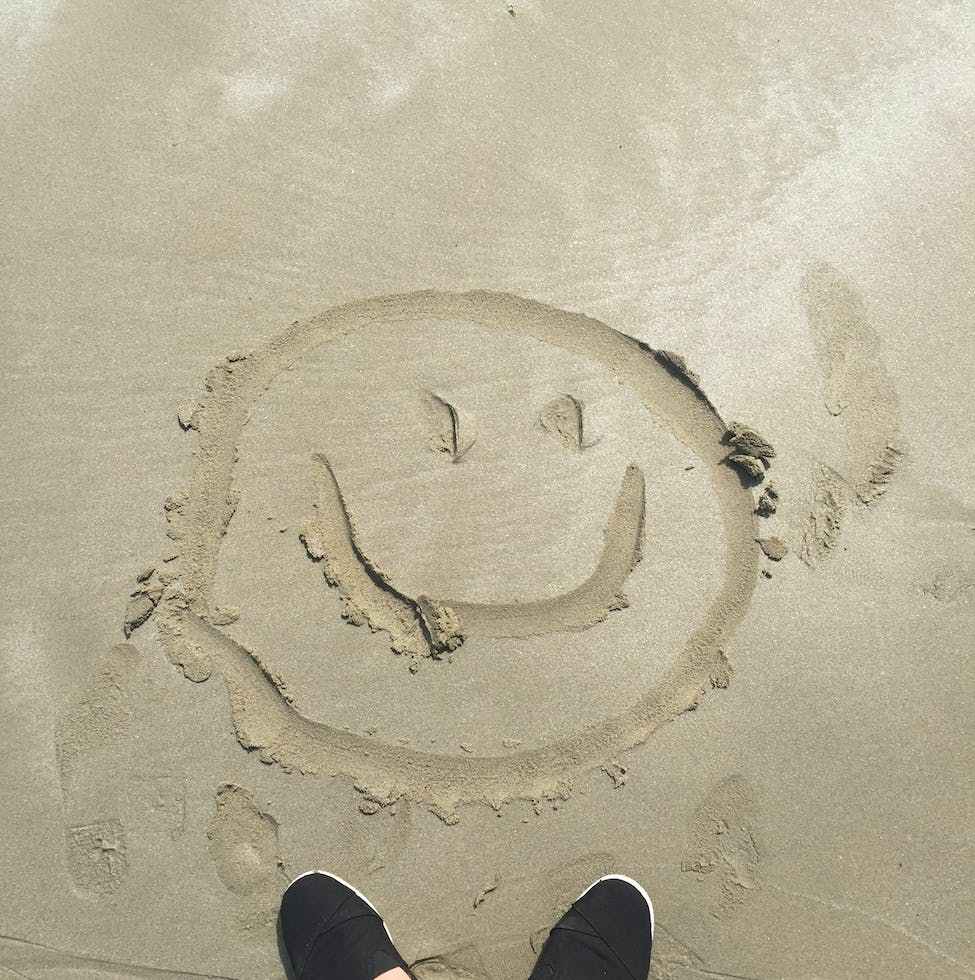 smiley drawing on sand