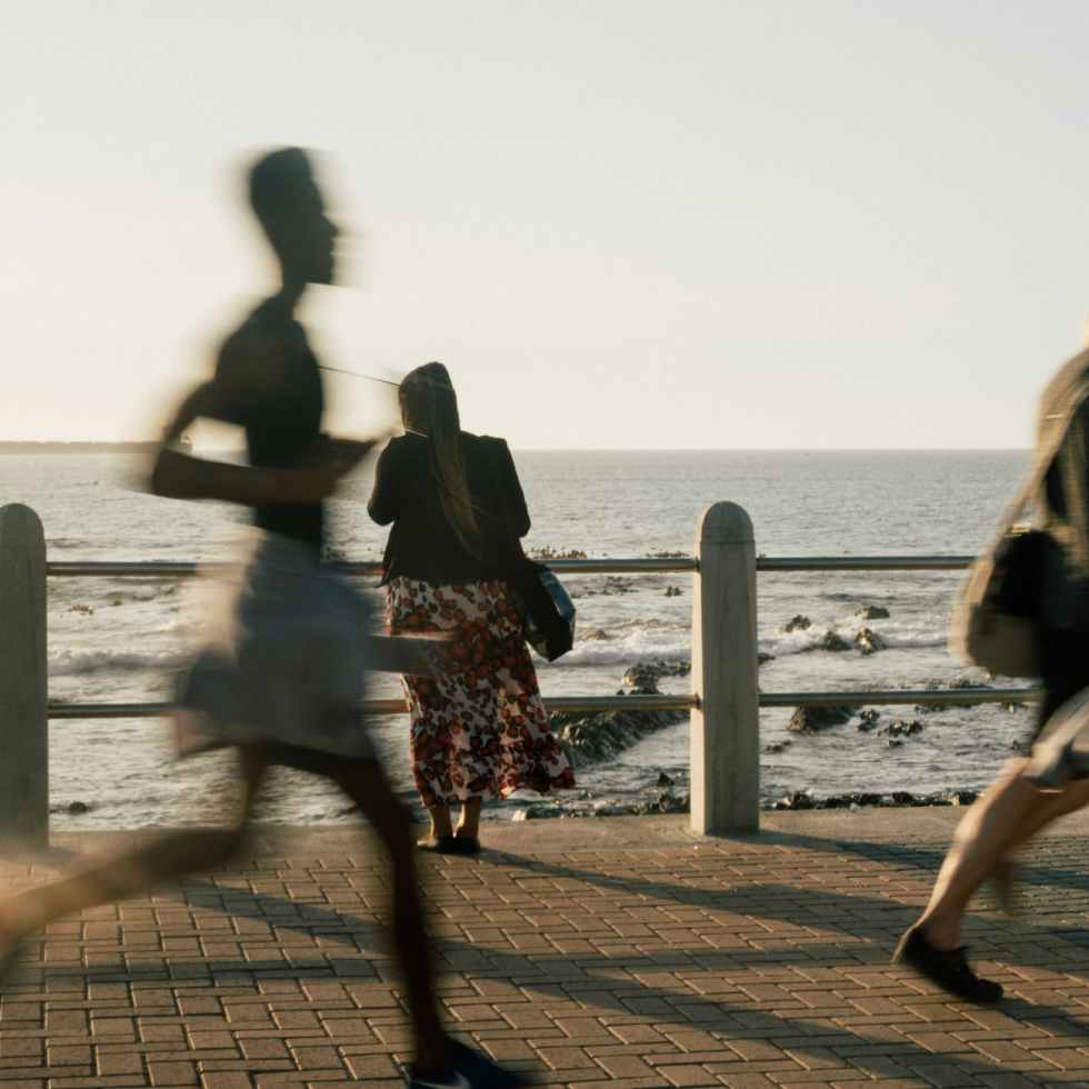 woman standing on background while people walking on promenade